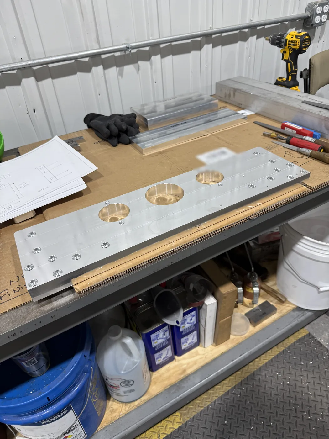 Long aluminum plate with three large bores and tapped holes